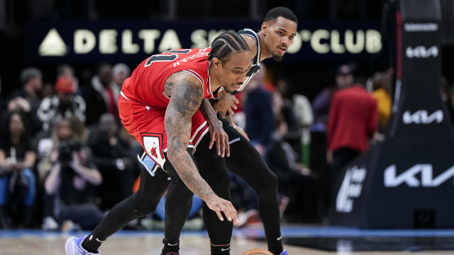 Chicago Bulls forward DeMar DeRozan (11) and Atlanta Hawks guard Dejounte Murray (5) battle for control of the ball during the second half at State Farm Arena.